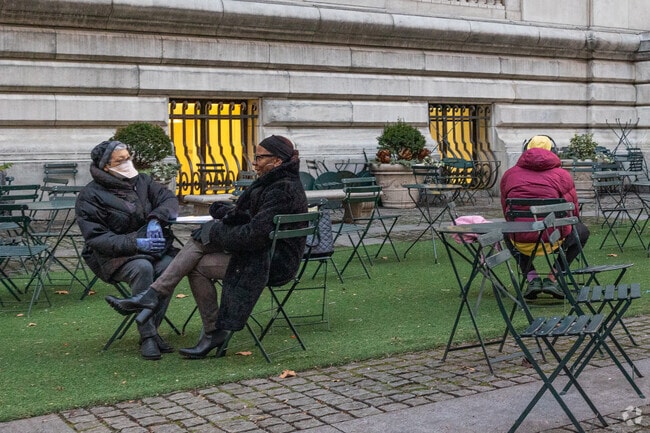 Friends meet outside the New York Public Library in Midtown East.