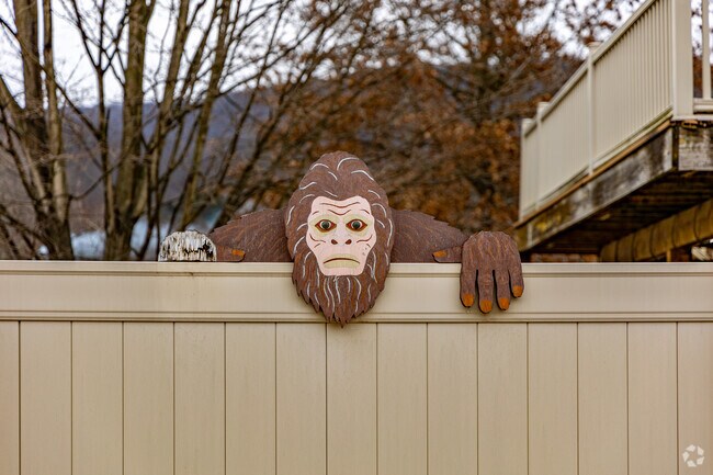 A wooden sasquatch peaks off a Bolivar resident's fence.