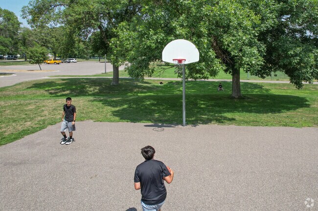 Friend playing basketball at Palmer Lake Park.