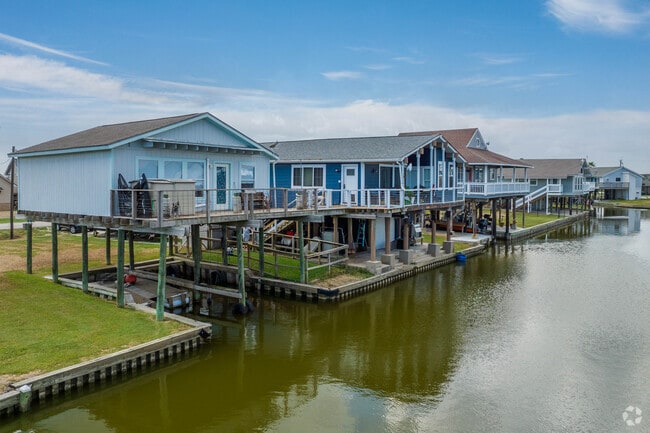A row of stilted canal homes sits alongside the Oyster Creek waterway.