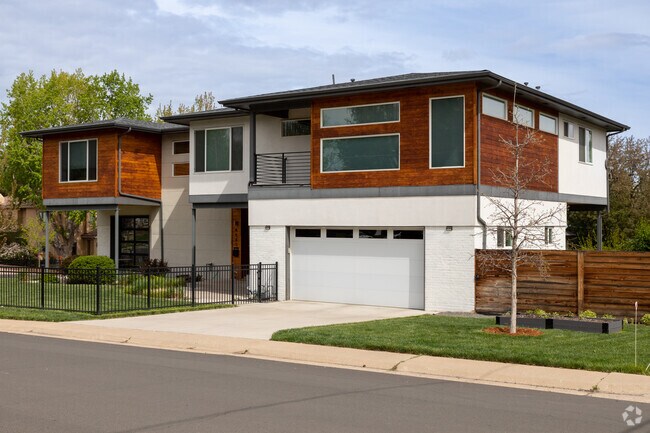 A beautiful split level, modern style home in University Hills featuring a two car garage and fenced yard.