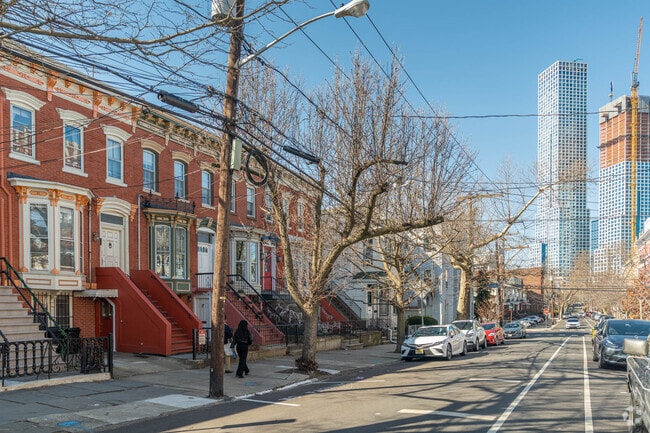 Old trees take their places on the sidewalks of Journal Square.