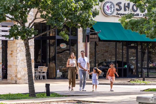 A young family enjoys the afternoon at Creekside Park Village Shopping Center.