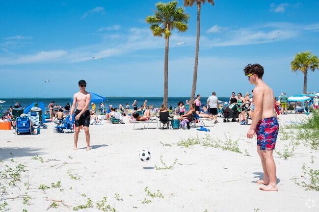 Friends play soccer at Howard Park Beach.