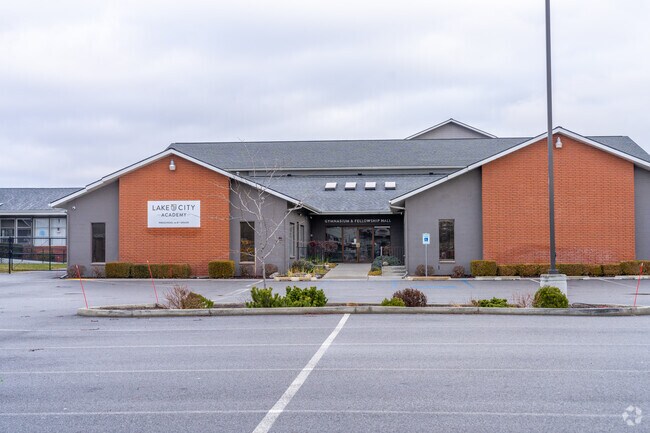Lake City Academy features a large parking lot in front of the school.