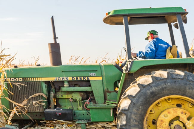 Rolling through the heartland of Ontelaunee, this farmer steers progress on his tractor.