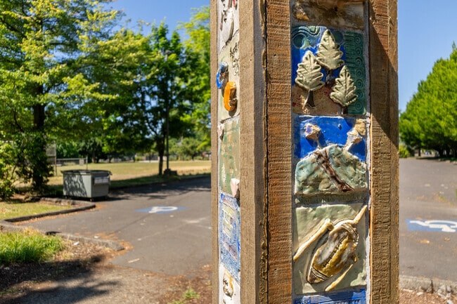 Student ceramic tiles on a totem welcome teachers to Beach Elementary School.