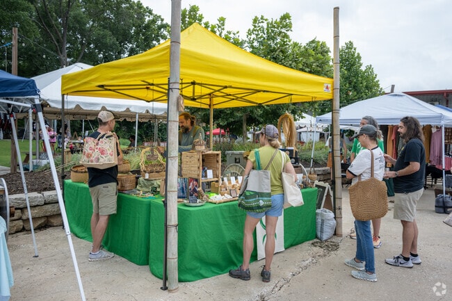 Locals enjoy visiting a woodworking tent at the Fretwell Market in the area.