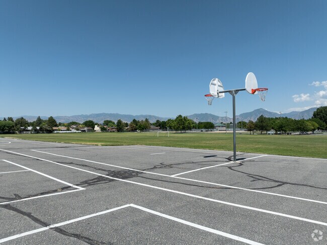 Basketball courts at Vista Elementary School have views of mountains and trees.