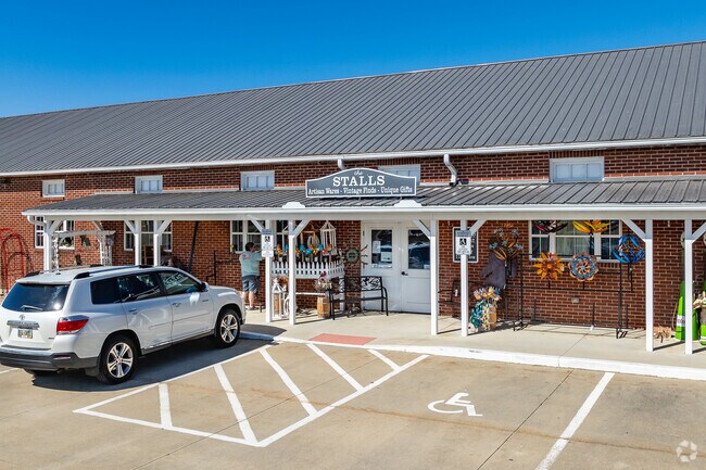 three restored barns that have been turned into shops and a café.