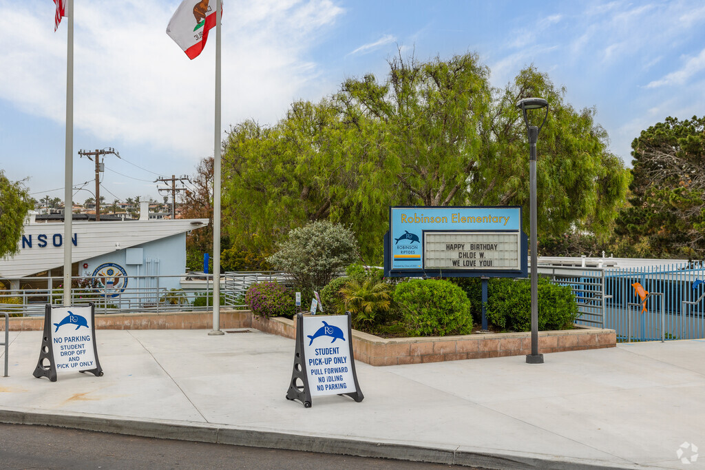 The entrance sign to Robinson Elementary School stands right above a stair walkway.