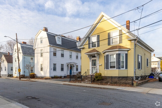 A row of homes on Bridge Street in Salem includes a colorful New Englander-style house.
