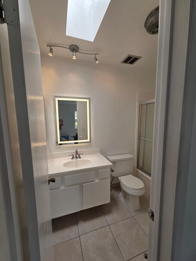 bathrooms have skylights and lighted mirrors