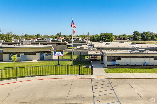 An American flag waves above the entrance to Mark Twain Elementary School in Corcoran.