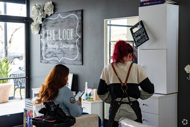A lady waits patiently for her haircut to begin at The Look Beauty Lounge.