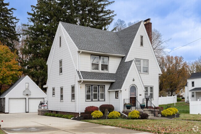 A three story Tudor Revival style home with detached garage in Downtown Massillon.