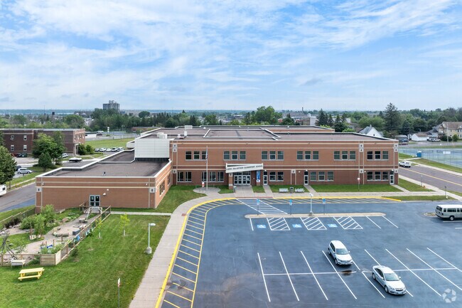 Laura MacArthur Elementary School has a garden and large parking lot.