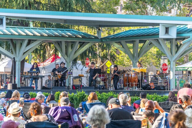 A Santana Tribute band plays as the crowd vibes to the rhythm of the electric guitar.