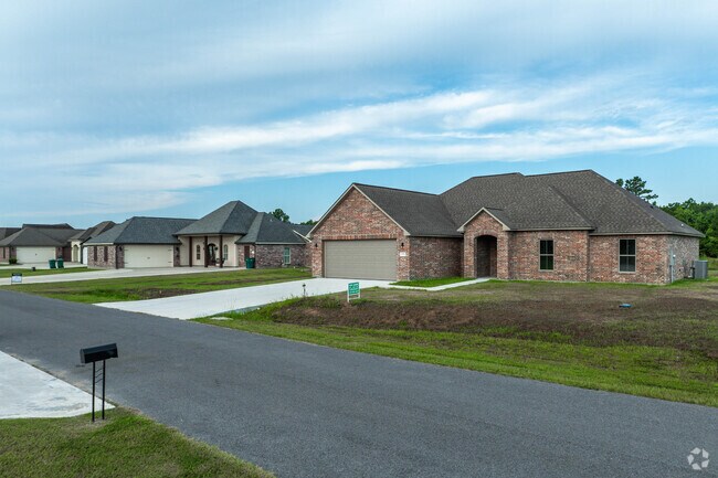 A row of homes proudly sit along a neighborhood street in Carlyss.