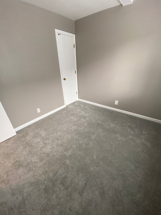 First floor bedroom or home office with new paint and carpet