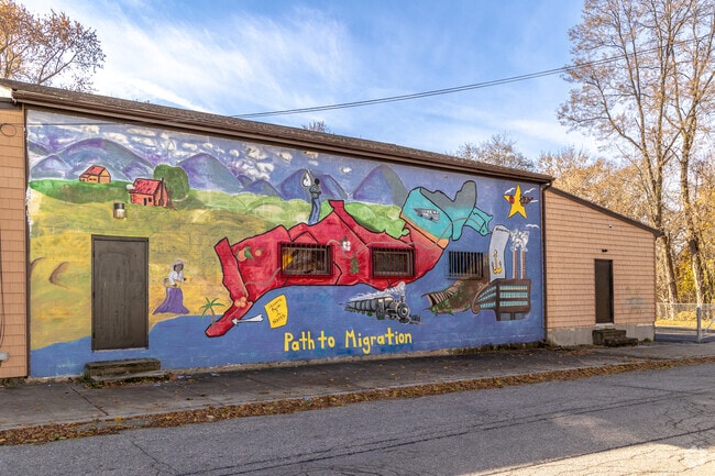 The mural on the walls of the Tyra Club depicts the historical roots of migration.