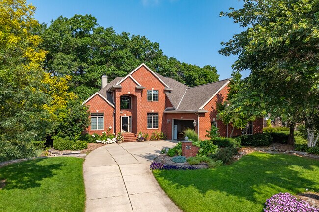 A brick home sit on a wooded lot in the Wilder Park neighborhood.