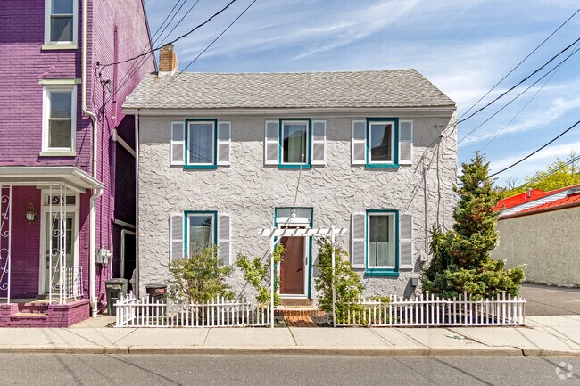 Whimsical architecture, colorful shutters, and white picket fences create a vibrant tapestry that captures the spirit and soul of Lambertville living.