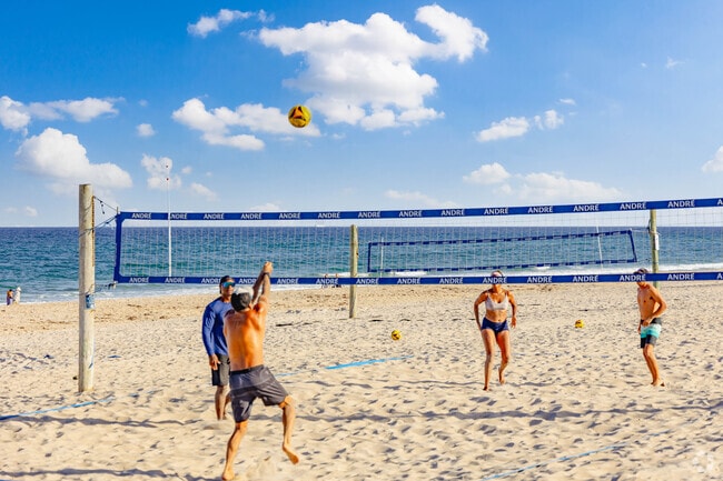 Friendly competition on the beach volleyball court in Delray Beach.