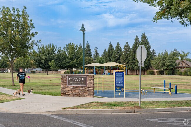 Resident walks dogs at Schroth Park in Exeter.