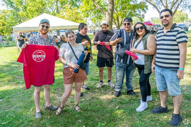 Berwyn residents show of their merch from10th Annual Berwyn Brewfest in Proska Park.