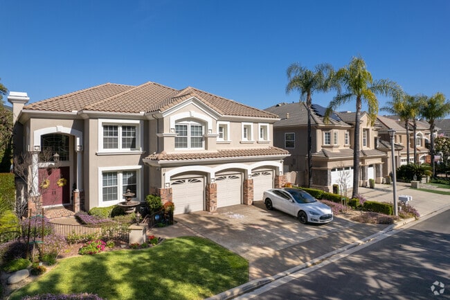 Hilltop communities with large homes feature multi-car garages and tidy yards on tight lots.