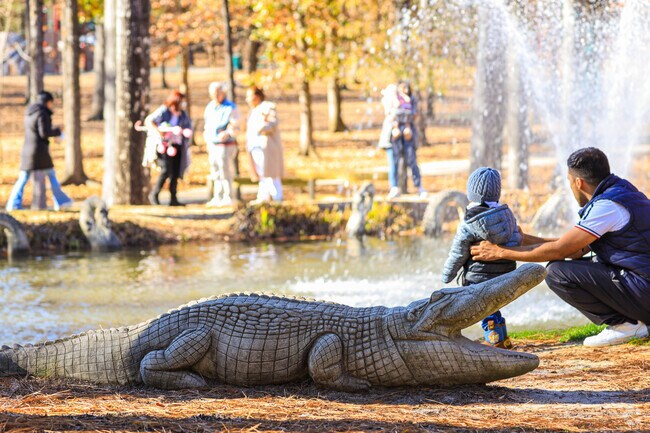Children and adults enjoy the aligator and fountain at Irmo Community Park.