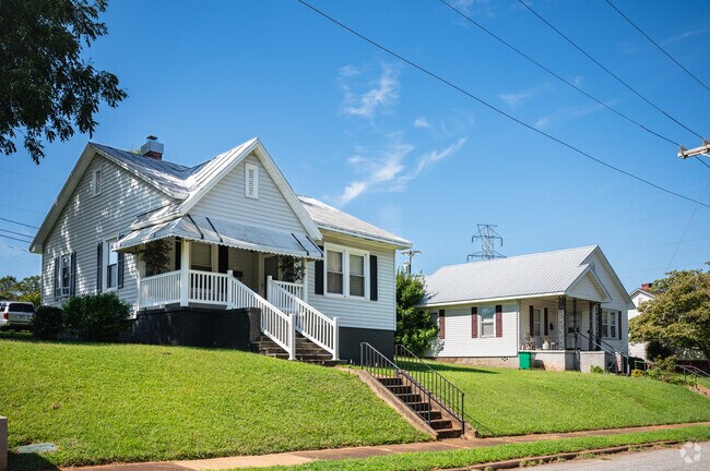 White Craftsman homes with small front yards line Saxon streets.