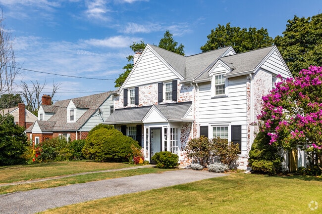 A stunning row of Tudor-inspired homes in Indian Spring offer pristine landscaping and driveways.