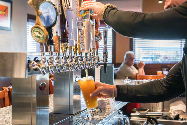 Friends come to gether at Coastal Grille for beer and great food in Spring Ridge.