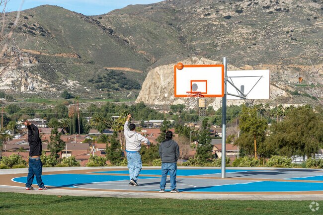 Shadow Rock Park hosts basketball games alongside playgrounds and open green space.