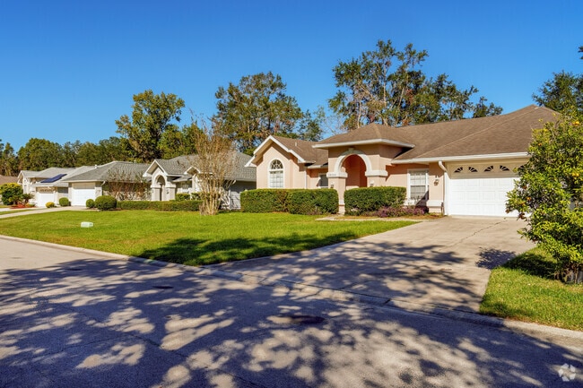 A row of meticulously maintained homes features beautiful landscaping in Broadmoor.