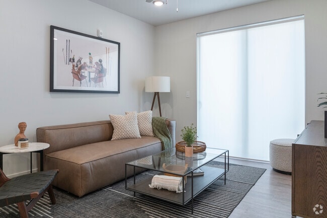 Spacious living room with retractable window shades.