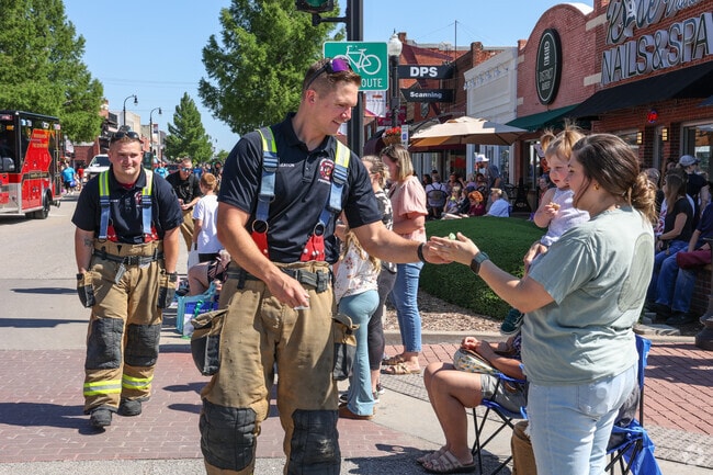 Broken Arrow Fire Department hands out buckets of candy along the parade route at Rooster Days.