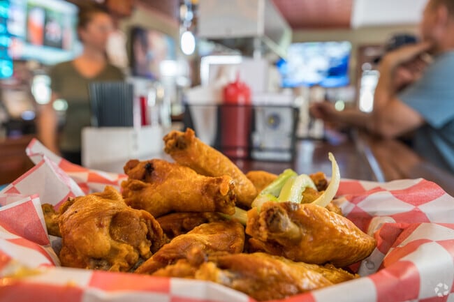 Sharky’s Wings & Raw Bar near Alpha is known for its crispy wings and delicious sauce menu.