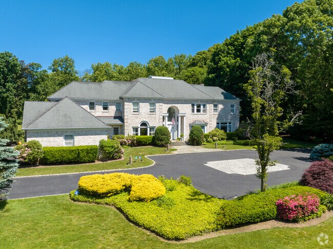 Tree-lined paths lead to grand estates throughout Old Brookville’s quiet streets.