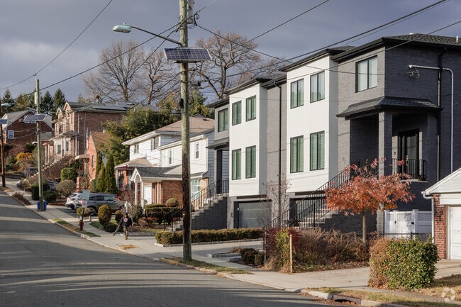 Modern duplexes often share the street with older single family homes in Fort Lee.
