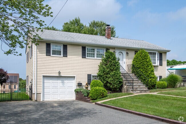 A raised ranch style home in the North Tiverton neighborhood is beautifully maintained.