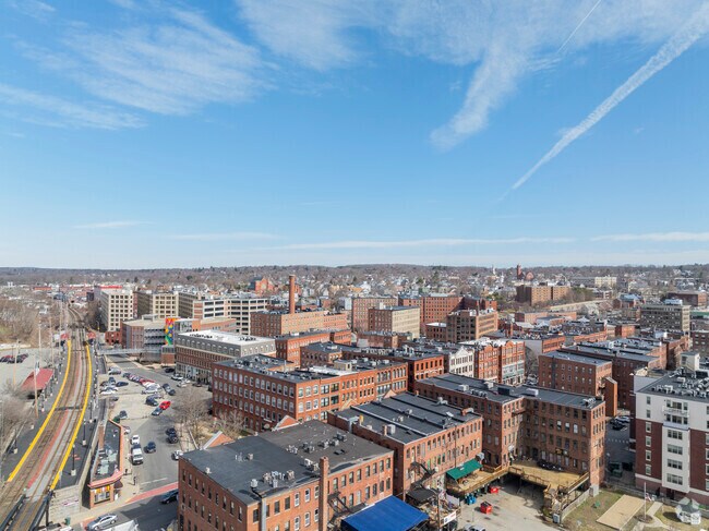 An aerial view of Downtown Haverhill reveals a dense mix of historic brick buildings, riverside charm, and vibrant residential pockets nearby.