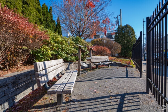 Take a seat at one of two benches at the Henry O. Hansen Park in Magoun Square.