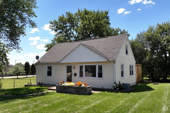 Single-family home with a well-manicured flower bed and lawn in Harter Heights, Canton.
