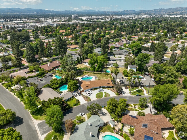 The Northridge neighborhood is filled with trees and surrounded by mountains.