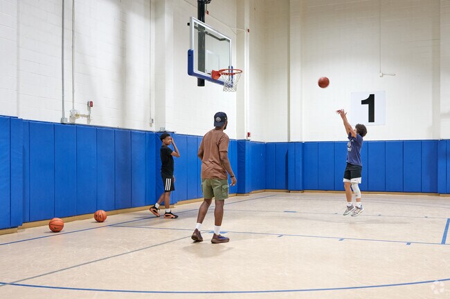 Kids play basketball at the Rochester Community Sports Complex in Brown Square.