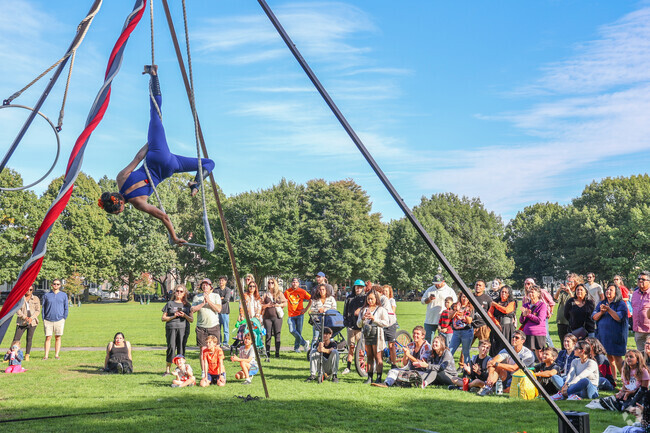 The crowd is amazed by the aerial acrobatics at the Haunted Happenings Marketplace.