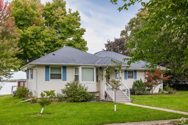 This cottage features baby blue shutters and steps to the front entrance in Newport Cove.